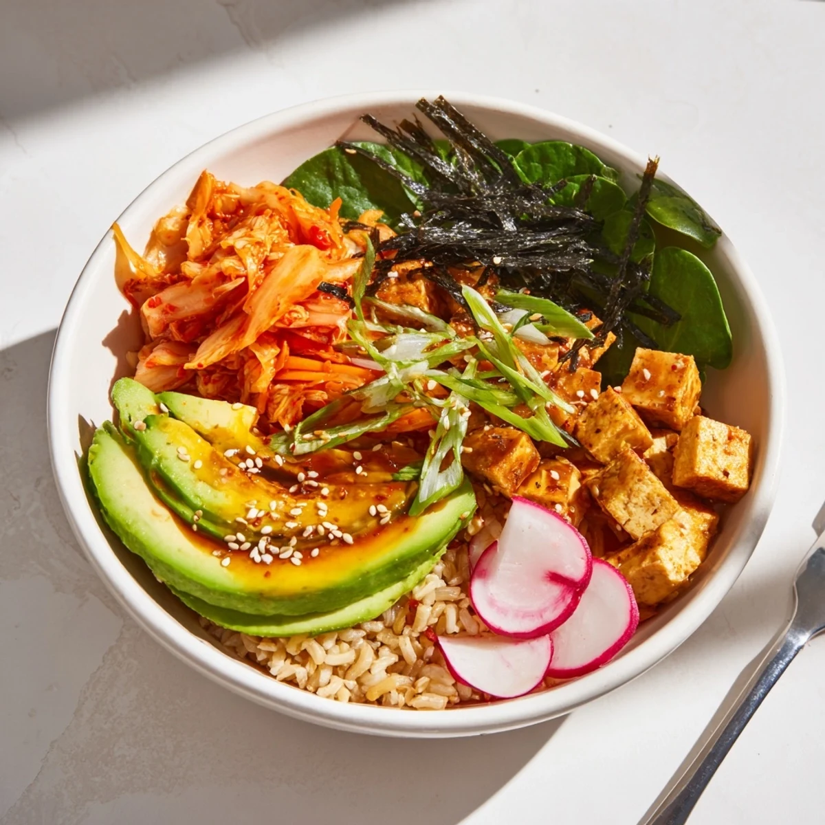 Delicious fermented vegetable bowl garnished with avocado and sesame seeds.  