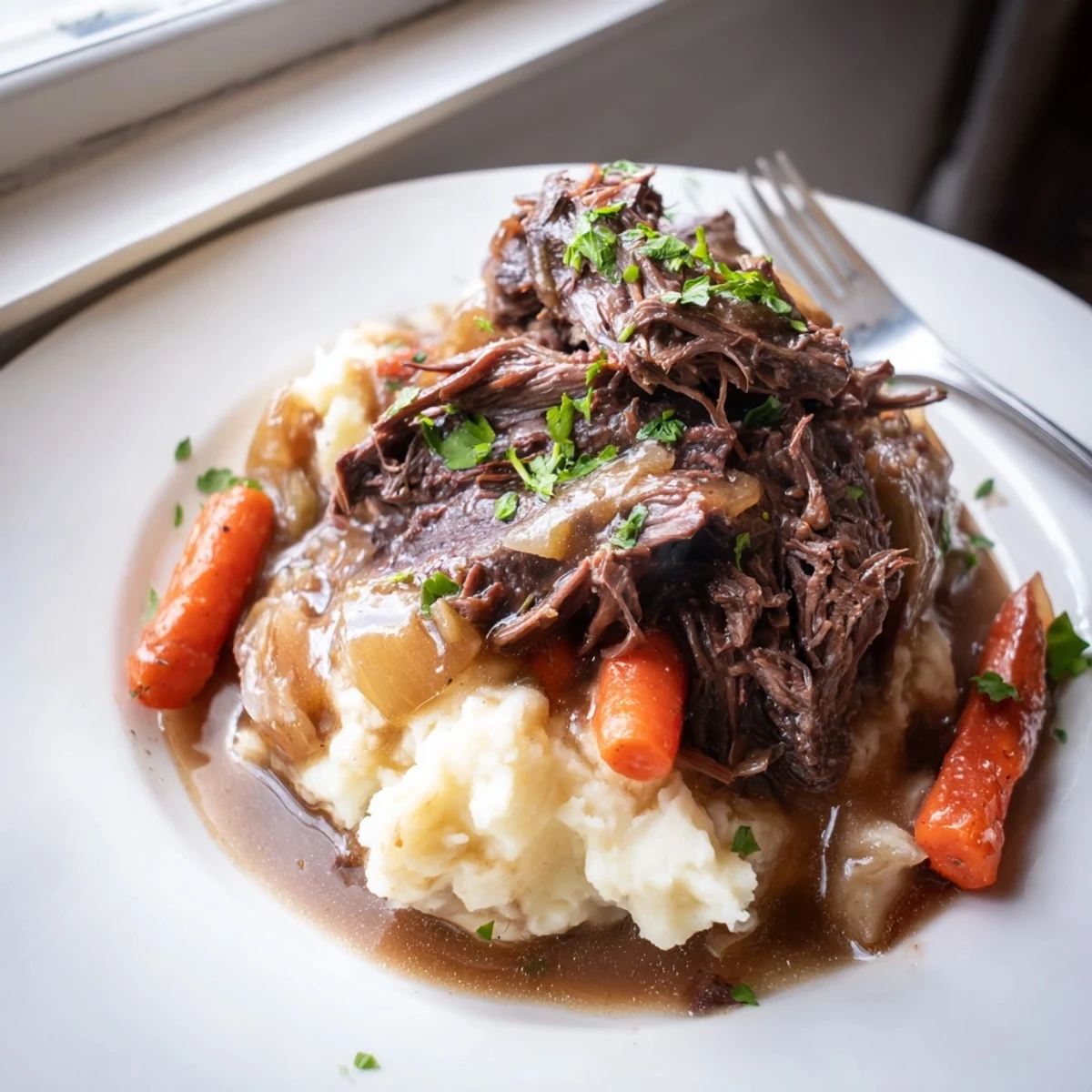 Slow Cooker Pot Roast with Mashed Potatoes served with rich gravy and fresh parsley.  