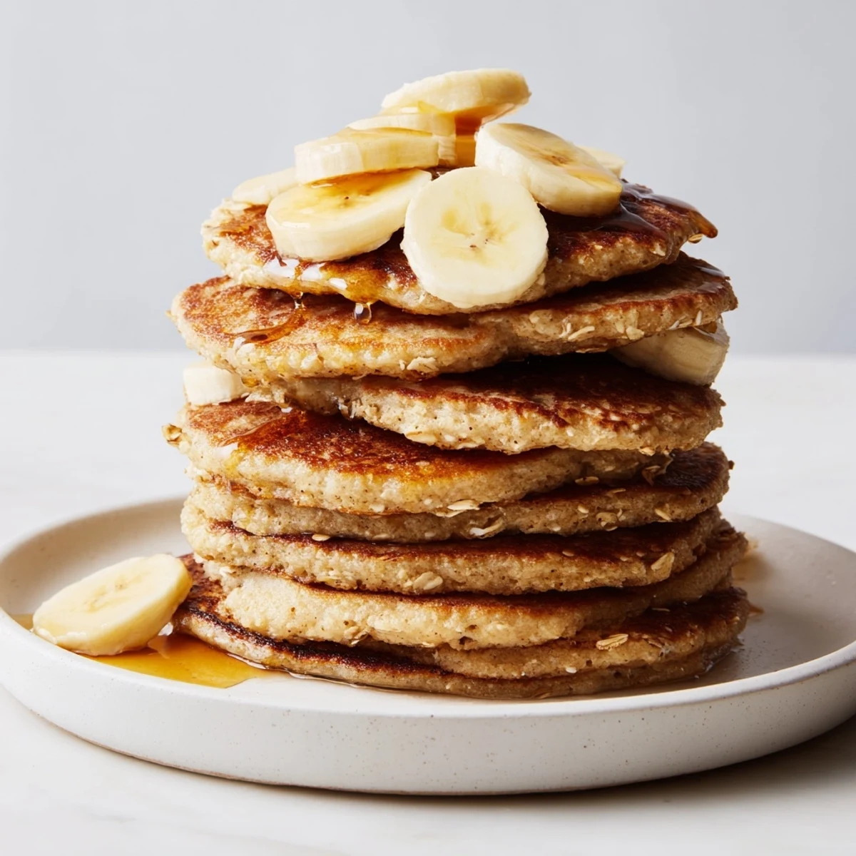 Close-up of freshly cooked banana oat pancakes, showcasing a comforting breakfast made easy.