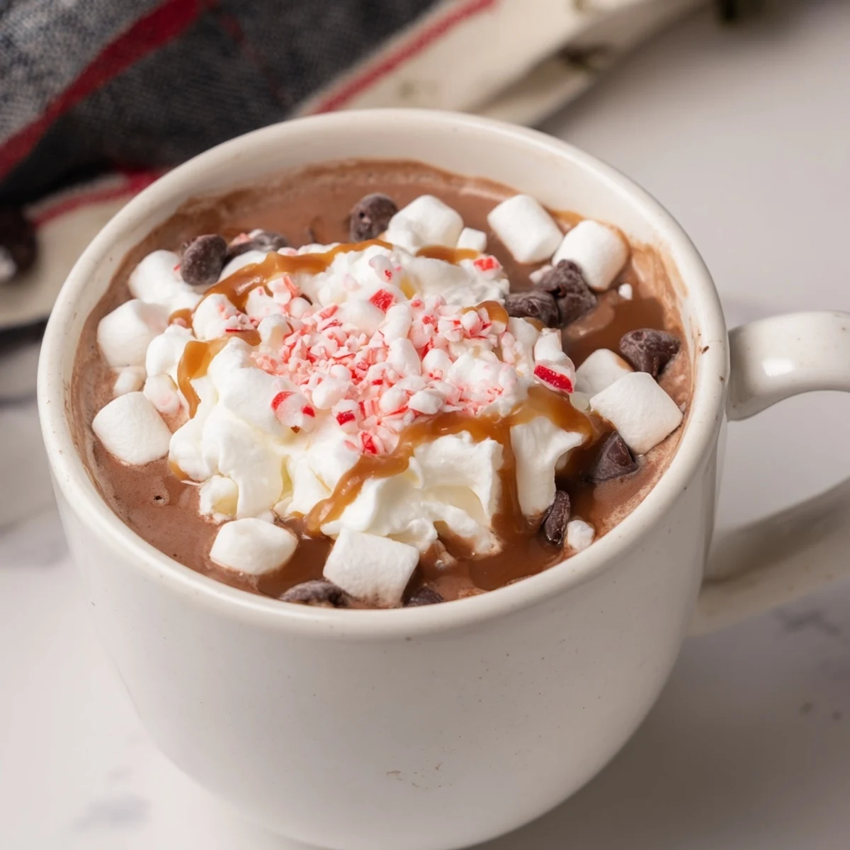 Steaming Reindeer Hot Cocoa Bar with mini marshmallows and crushed candy canes ready to be served.