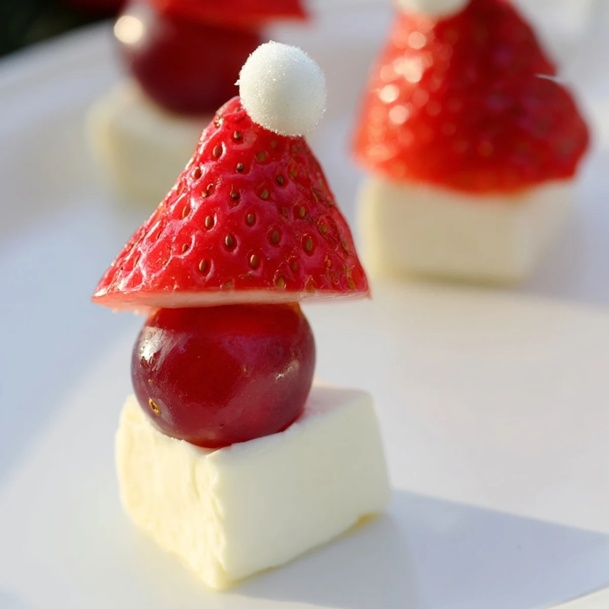 Vibrant Santa Hat Fruit and Cheese Platter with juicy strawberries, creamy mozzarella, and sweet grapes.