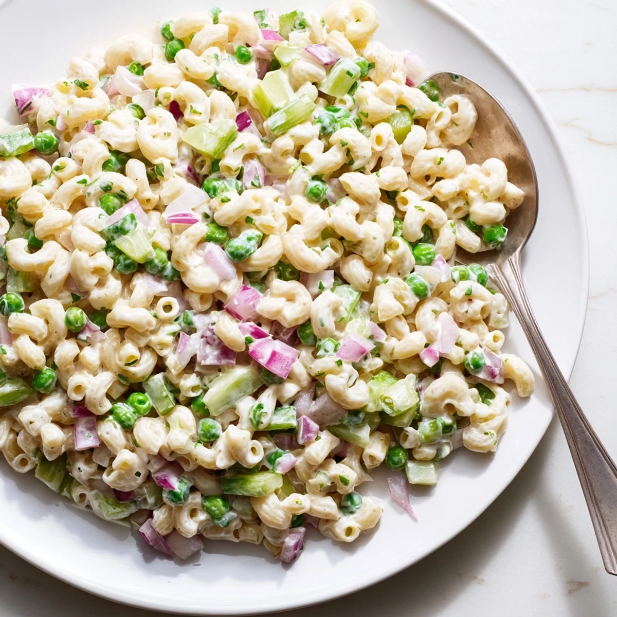 Creamy Dill Pickle Pasta Salad featuring ditalini pasta, crunchy diced pickles, and sweet green peas in a zesty dressing.  