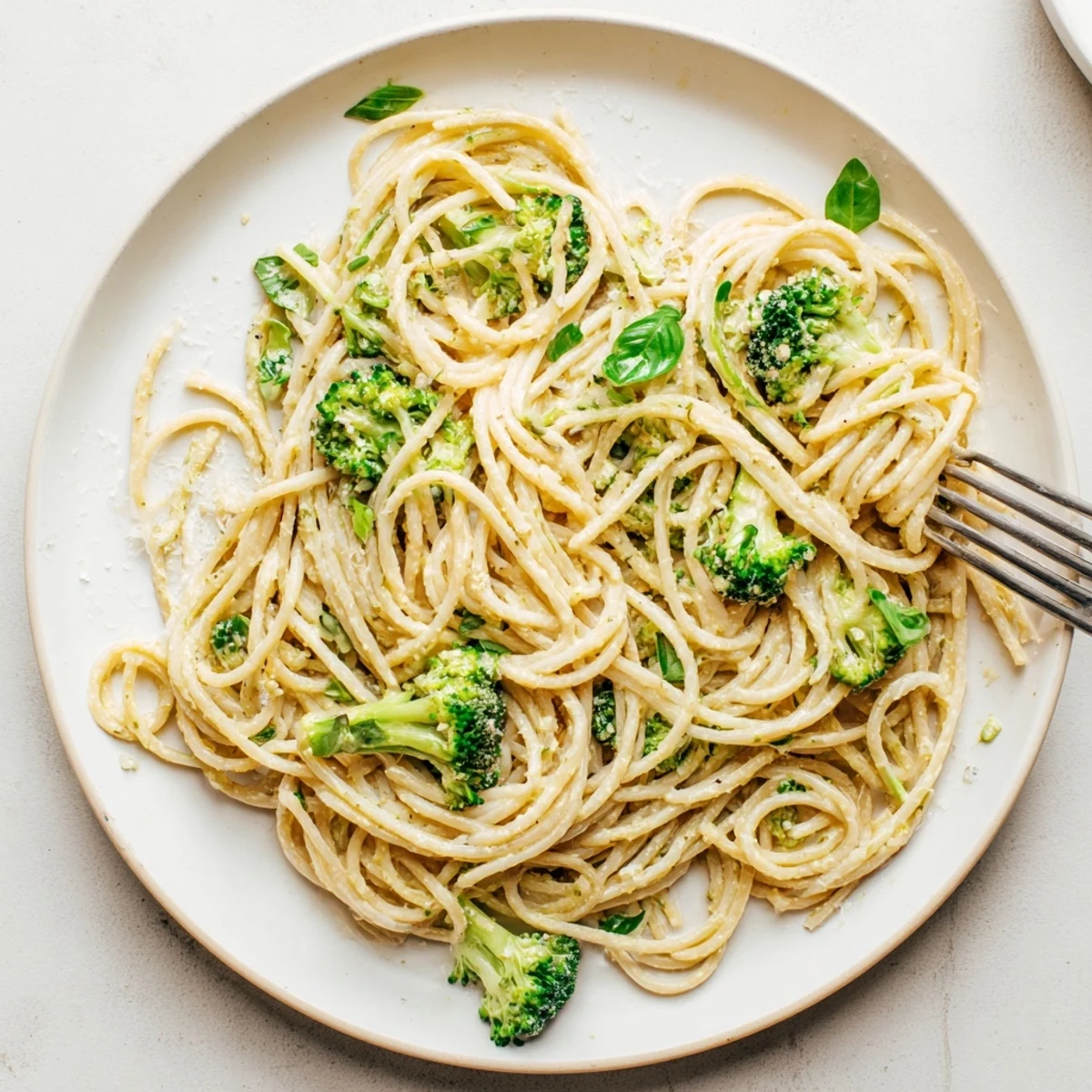 A single pot holds vibrant One-Pot Lemon Broccoli Pasta, with bright green broccoli florets and lemon zest resting on silky, garlic-infused noodles.  