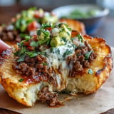 Low-carb cloud bread taco shells hold juicy seasoned beef and zesty tomato salsa for a satisfying meal.  