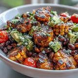 Grilled Corn and Black Bean Taco Salad with fresh vegetables, zesty lime dressing, and crispy tortilla chips for crunch.  