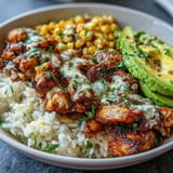Juicy spiced chicken crowns these flavorful Street Corn Chicken Rice Bowls.