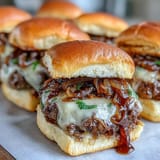 Juicy smashed beef patties piled high with sweet onions on toasted slider buns.