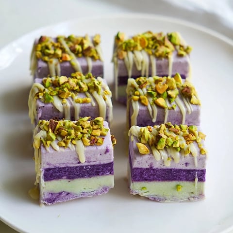 Creamy ube and pistachio ice cream bars, drizzled with condensed milk for indulgence.  