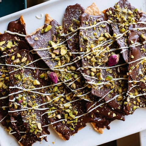 Close-up of Pistachio Dubai Chocolate Bark: a decadent treat layered with pistachios and white chocolate.
