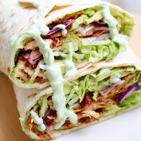Grilled chipotle chicken, sliced thin, layered with crisp romaine, creamy avocado, and tangy yogurt sauce in a warm flour tortilla.