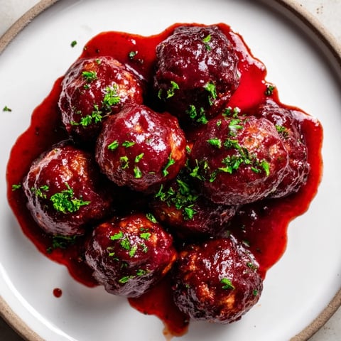 A slow cooker filled with glistening cherry BBQ meatballs, ready to serve and enjoy.