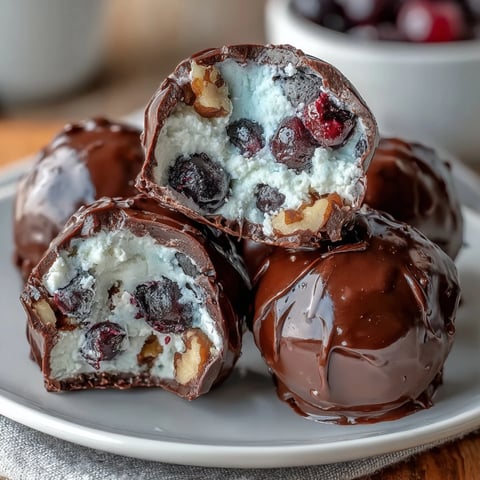 Wholesome frozen blueberry yogurt clusters with crunchy walnuts and dark chocolate coating, perfect for healthy snacking.  