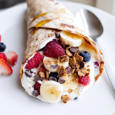Imagine vibrant, fruity filling within a Cinnamon Toast Crunch Breakfast Wrap, drizzled with honey.