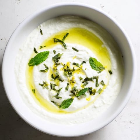 Tangy whipped feta dip with a bright lemon-mint topping, served with pita triangles and fresh veggies.