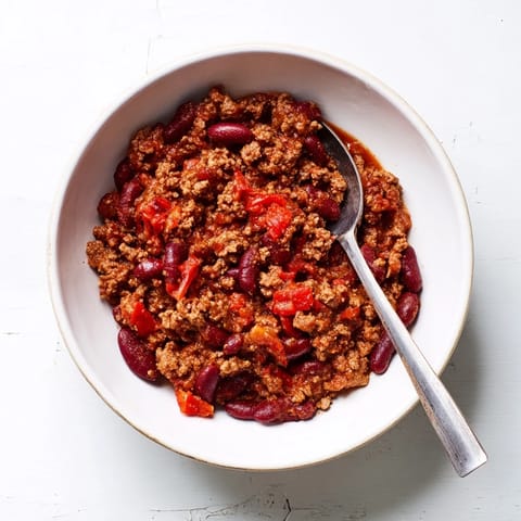 This easy slow cooker chili shows chunks of beef, tomatoes, and beans, a perfect family meal.