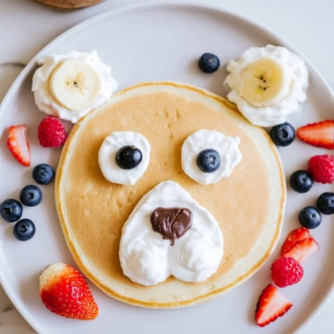 See this fun and festive Polar Bear Pancake Stack Board with adorable decorated pancake faces and blueberries.
