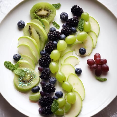 Vibrant Aurora Borealis Sweep fruit arrangement with layers of grapes, kiwi, and berries for a beautiful snack.