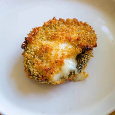 Close-up of freshly fried Crispy Chickle Bites, with melted cheese and a crispy, golden crust.