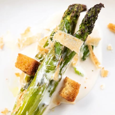 Golden asparagus spears and crunchy croutons piled high on fresh romaine, finished with a creamy yogurt Caesar dressing and freshly cracked black pepper.