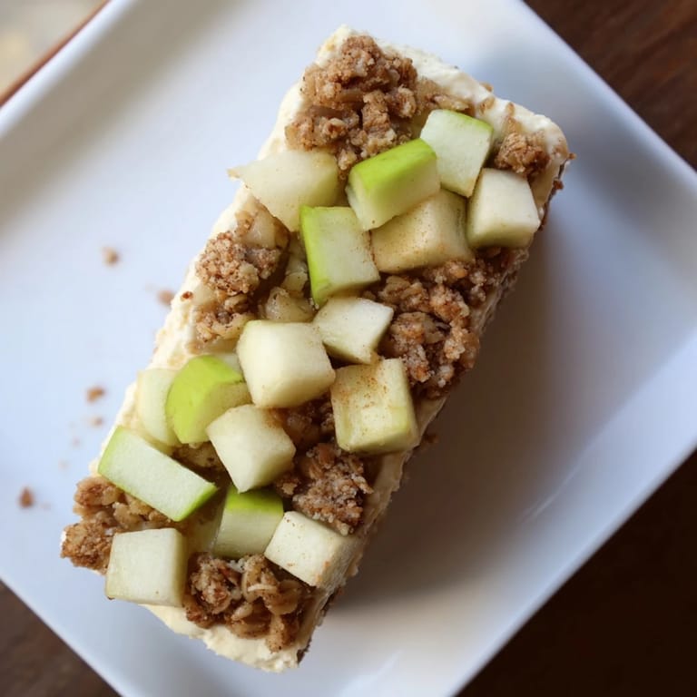 These rich Apple Crisp Cheesecake Bars feature layered textures, including a creamy cheesecake center.