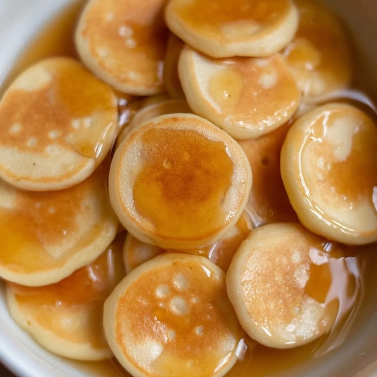 A bowl of delicious and fluffy, bite-sized Fluffy Pancake Cereal; easy, fun, and picture-perfect for everyone.