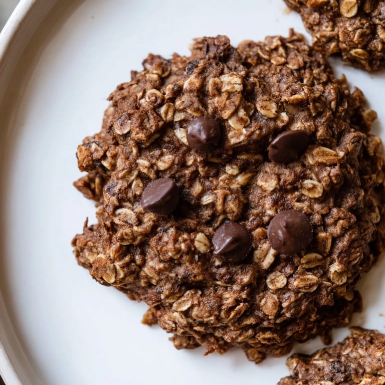 Golden-brown chocolate oatmeal breakfast cookies, speckled with chocolate chips, ready to eat.