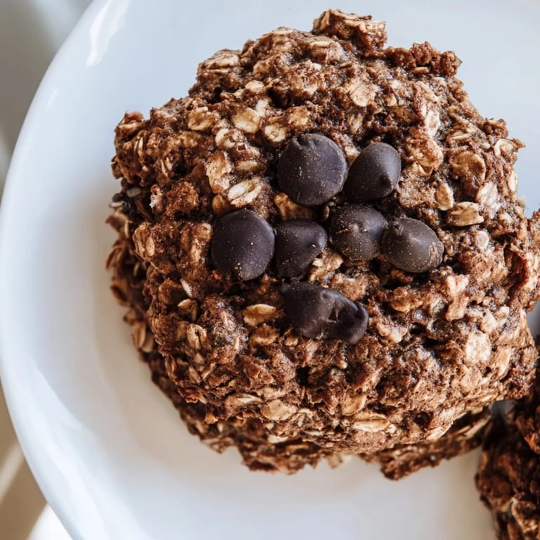 Close-up of a stack of moist chocolate oatmeal breakfast cookies, ideal for a quick, delicious snack.